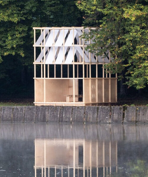 bordering a lake, grau architects' wooden pavilion in czechia nods to japanese tea houses